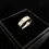 Thumbnail: Elegant brushed gold wedding band shown upright in black jewellery box