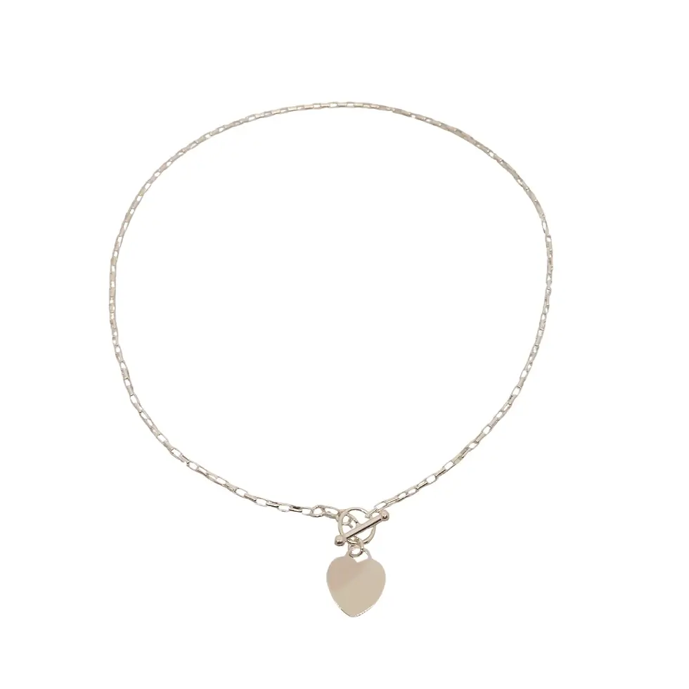 Full view of silver bracelet with heart pendant displayed flat