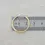 Thumbnail: Single 44mm tubular yellow gold hoop earring beside ruler for size reference