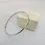 Thumbnail: Handcrafted 4mm gold bangle displayed beside gift box