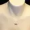 Thumbnail: Sterling silver lotus flower necklace displayed on mannequin bust