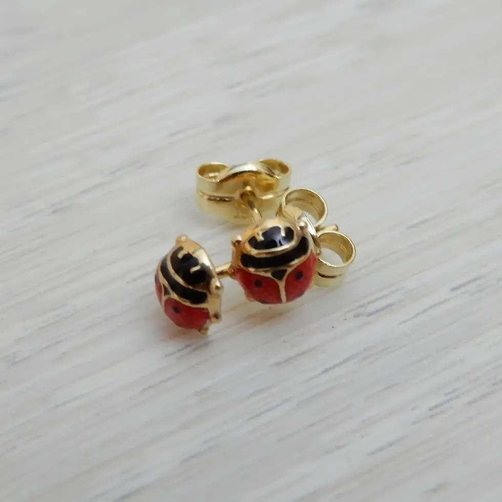 Thumbnail: Solid 9ct gold ladybird motif earrings displayed on neutral background
