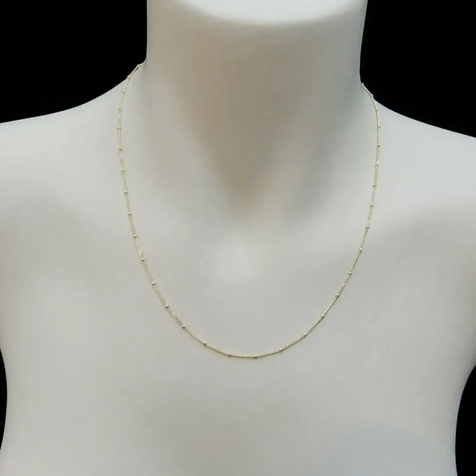 Thumbnail: Side view of 0.9mm Spiga chain necklace in 9ct Italian gold on mannequin