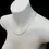 Thumbnail: Angled view of 9ct gold curb chain necklace draped on mannequin.
