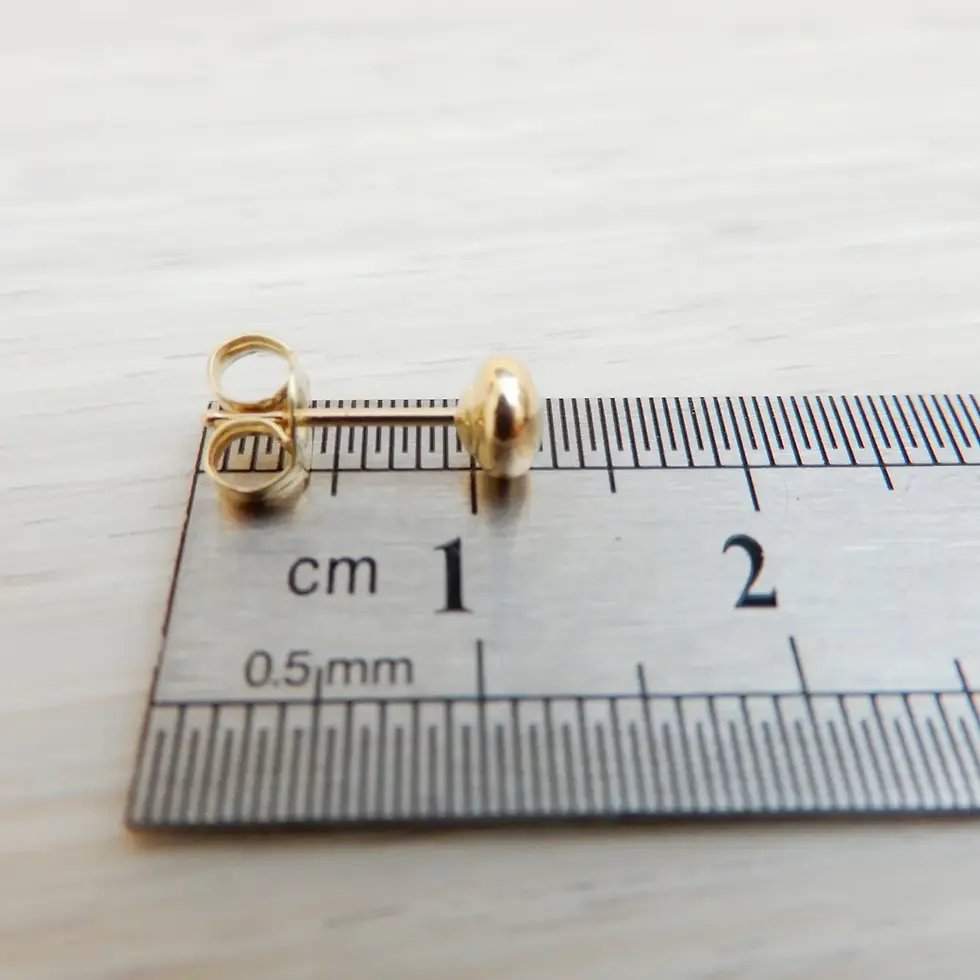 Thumbnail: Single flattened ball stud earring measured beside ruler for size reference
