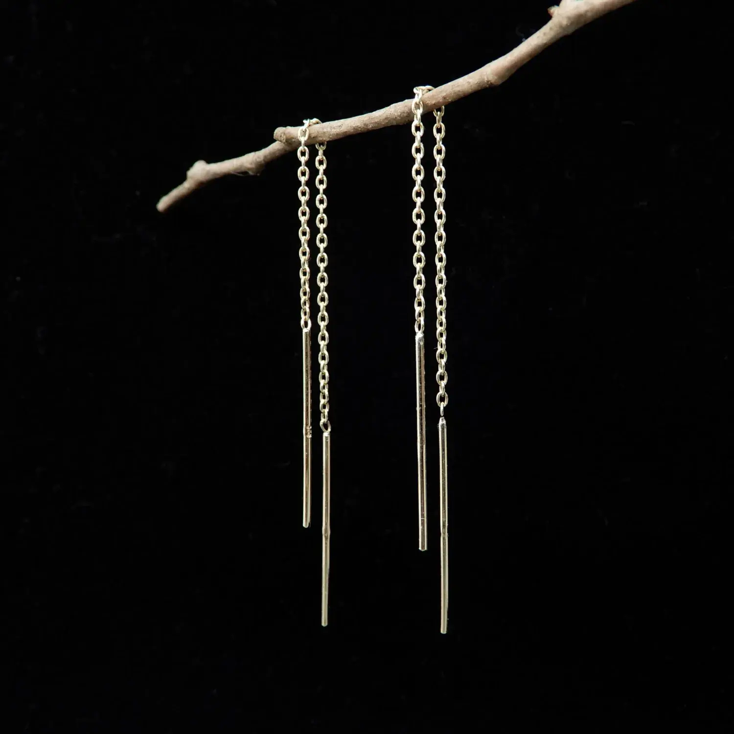 9ct yellow gold thread earrings with dangle design displayed on black background