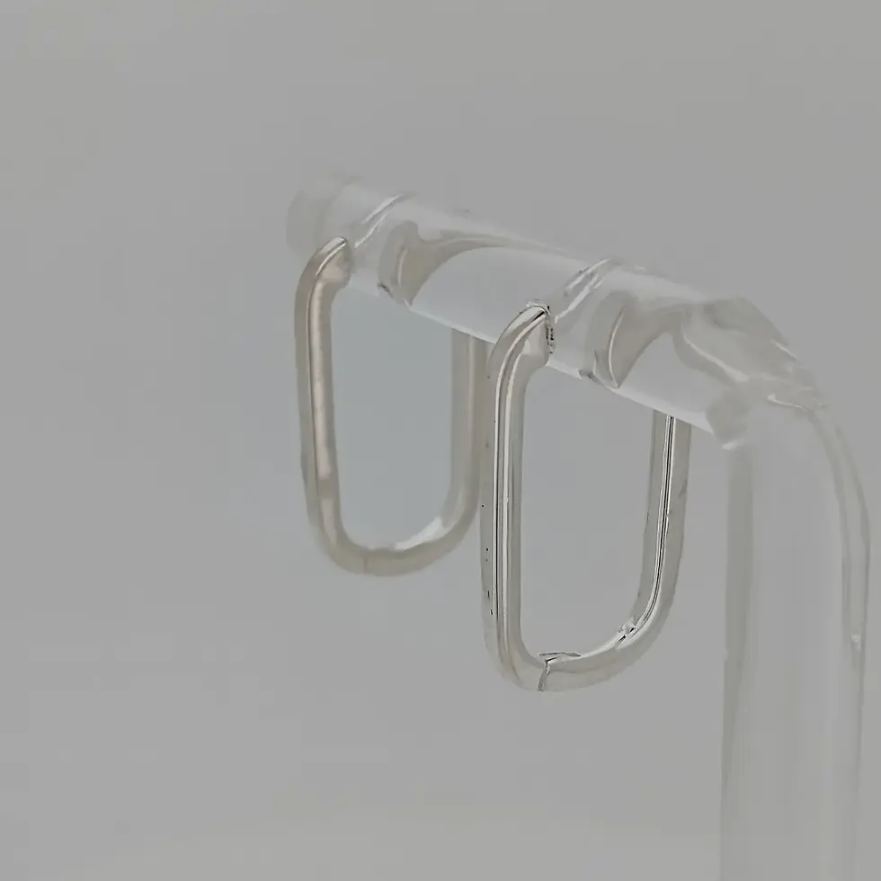 Thumbnail: Side angle of sterling silver 20mm rectangular slim huggie earrings on clear stand.