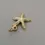 Thumbnail: Gold starfish charm pendant angled slightly downward with textured detail