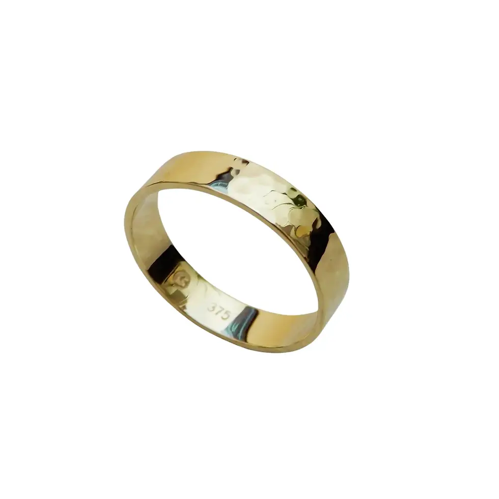 Handcrafted hammered finish wedding ring in polished yellow gold shown angled