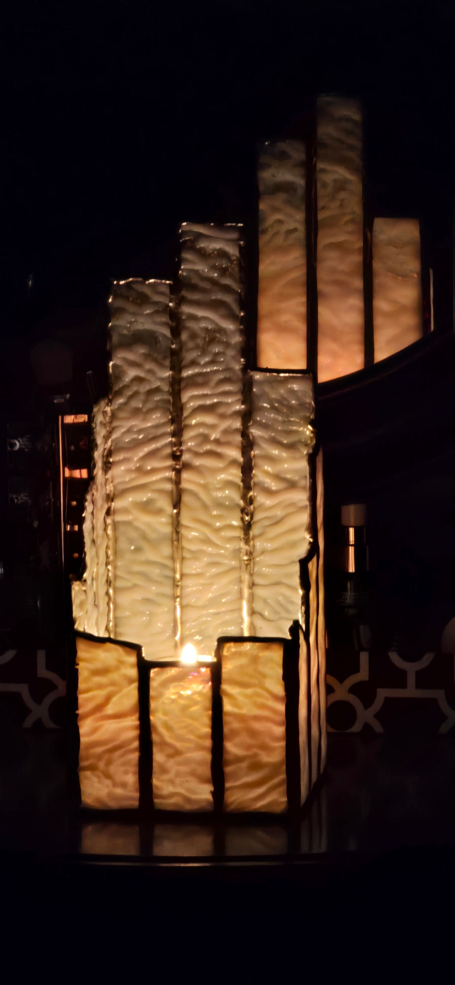 Illuminated glass art piece with textured panels