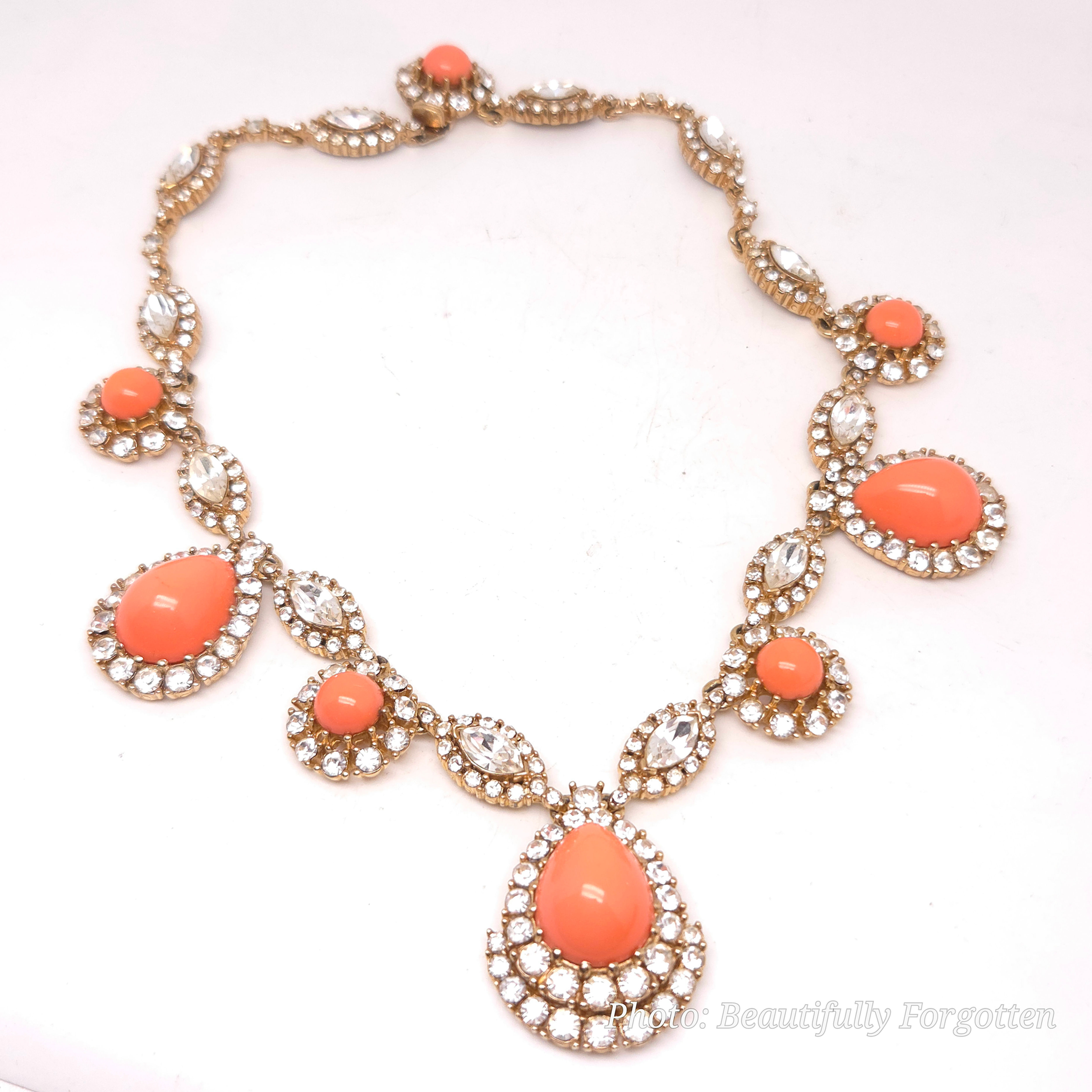 Signed Ciner gold-tone necklace with peach-coral cabochons and clear rhinestones