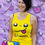 Thumbnail: front of bright yellow racer vest with smiley face and run happy text
