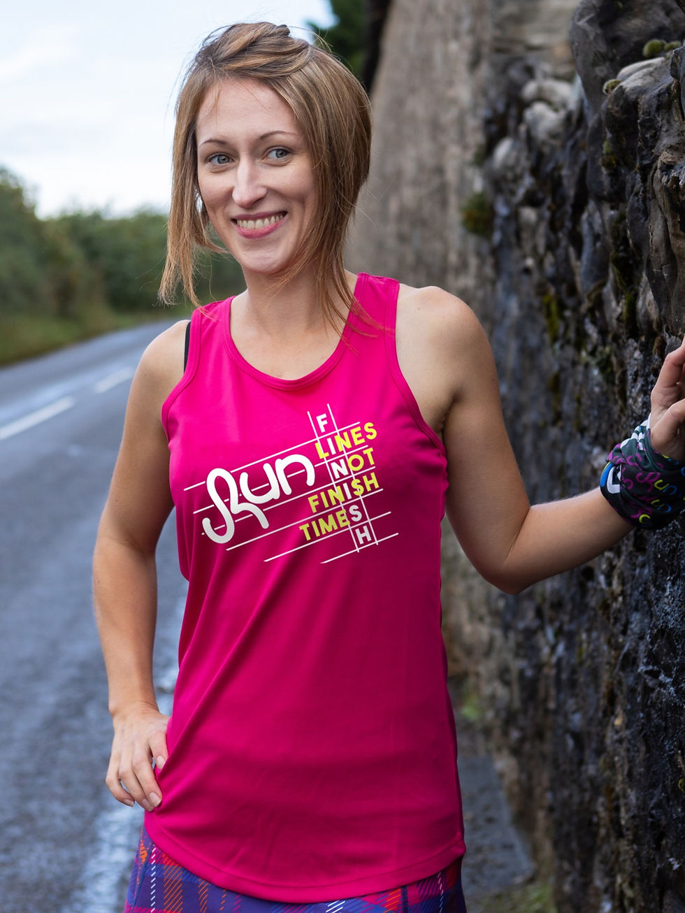 Bright pink race vest with wording finish lines not finish times