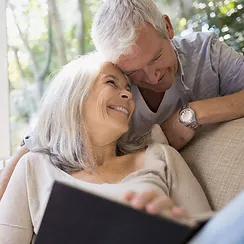 two people smiling with book