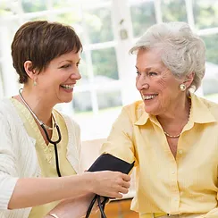 Older woman and nurse taking blood pressure