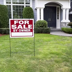 for sale sign in front of a house