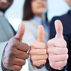 three people with their thumbs up