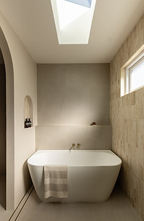 Freestanding bath beneath a skylight at Malia Beach House, Huskisson