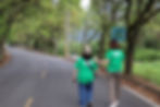two people walking and smiling in a road