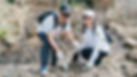 a man and a woman planting trees
