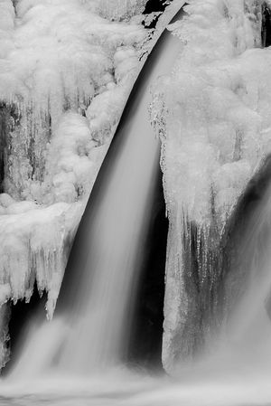 Black and white photograph of Bash Bish Falls during winter