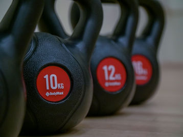 A group of people participate in a fitness class as part of Greg Newlands' 8-week transformation program in saltburn. The photo was taken by Jamie Bulman and is used to promote the program, which has seen a 4000% increase in sales thanks to the high-quality photos.