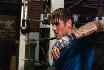 The photo on the website is from a high-quality photoshoot by Jamie Bulman featuring Luke Mabbott from Love Island. Luke is seen promoting gym clothing for BoohooMAN clothing in a boxing ring in teesside. The photo shoot has increased engagement by 350% and is being used to promote the clothing line.