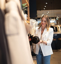 Claire Causton looking at clothes in a shop