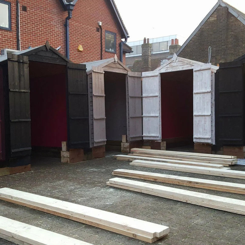 Timber booths under renovation with base structures raised and primed for painting — Leo & Co Bespoke.