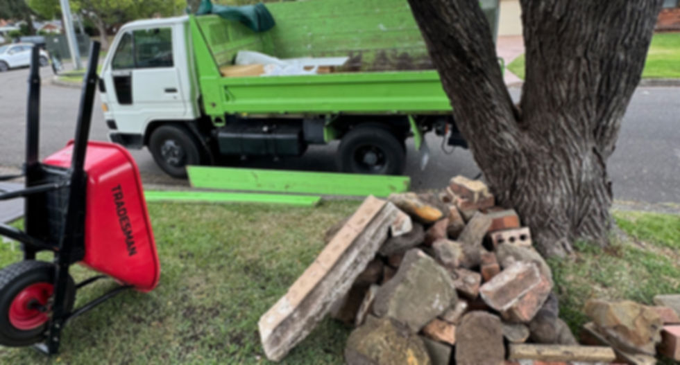 South-West Sydney rubbish removal crew with a truck and wheelbarrow collecting rubbish and debris.