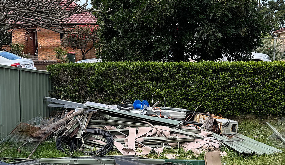 Collection of mixed waste including old blinds and metal roofing from a site in Russell Vale, NSW.