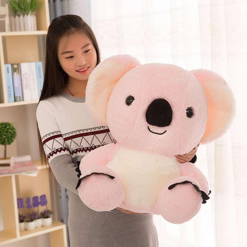 Young woman holding a pink koala plush toy Super Soft Koala Plush Toys in her hands.