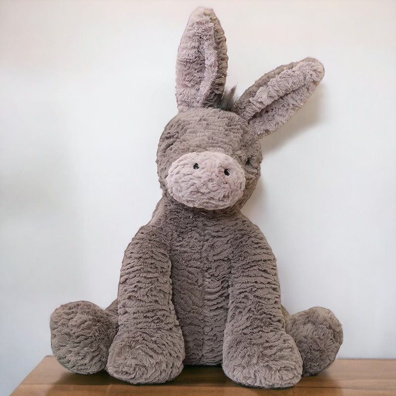 Grey donkey plush toy, sitting on a table, Plush Toys – Soft Donkey Cuddle Friend