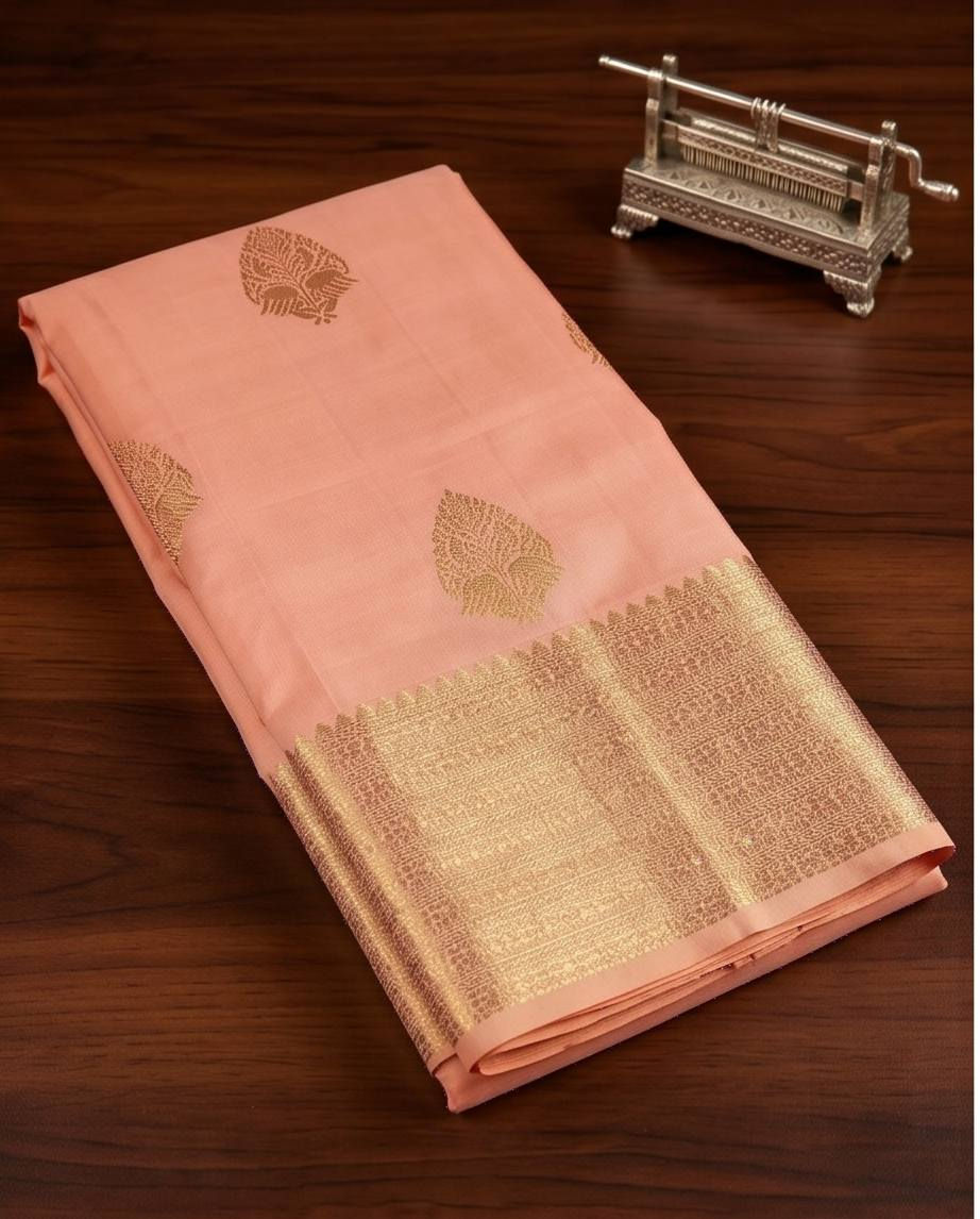 Thumbnail: Folded peach Pure Kanchipuram silk saree with gold border
