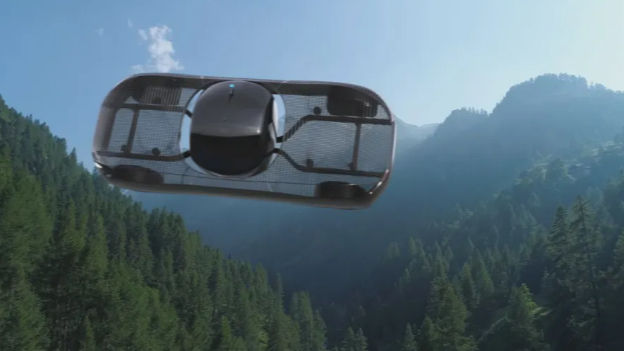 Flying drone over lush green forest with mountains in the background. The sky is clear and blue, creating a serene and futuristic mood.