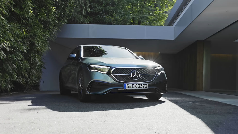 A sleek Mercedes car with license plate "S-EK 3373" is parked outside a modern house surrounded by greenery, under sunlight.