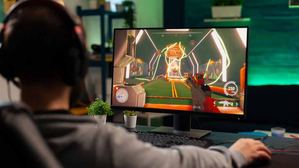 A person wearing headphones is gaming on a PC in a cozy room. The screen shows a bright, futuristic game interface with weapons and graphics.