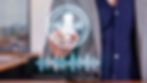 Person in suit points at holographic AI microphone icon with sound waves on a blurred office background, conveying modern tech innovation.