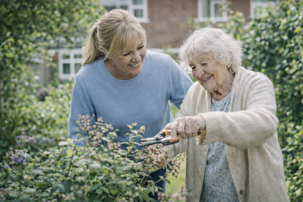A female live-in carer helping an elderly female client with the gardening - part of the Home Care Companions blog post on Can You Choose Your Live-In Carer