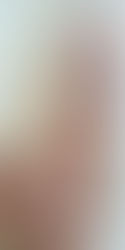 Jisamss posing nude beside a curtain, side view showing sensual breast curve.