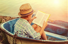 boy in boat reading