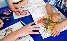 Preschoolers coloring on a table