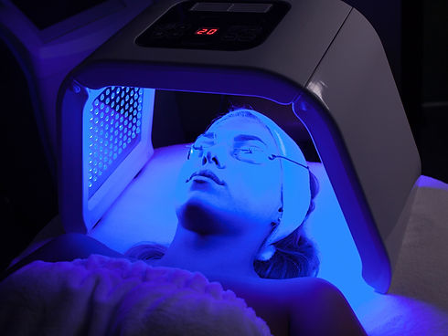 Young woman having LED light facial treatment in beauty salon_edited.jpg