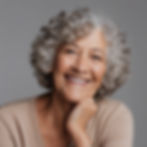 older woman with curly gray hair smiling.jpg