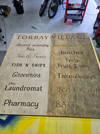 Close up of surface restoration of wooden sign in Signage works workshop