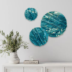 Elegant home decor featuring a trio of abstract sculptural discs in varying sizes, adorned in captivating turquoise blues.