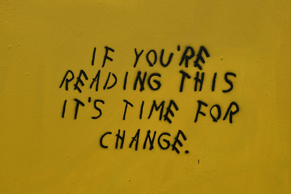 Black graffiti text on a bright yellow wall that reads "If you're reading this, it's time for change" — symbolizing transformation and bold action in business and marketing.