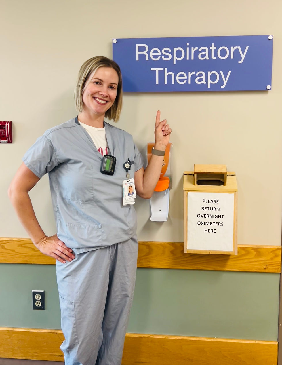 woman in scrubs pointing to respiratory therapy sign