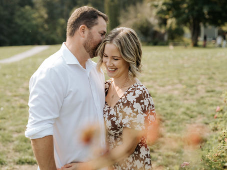 man kissing woman head in summer field