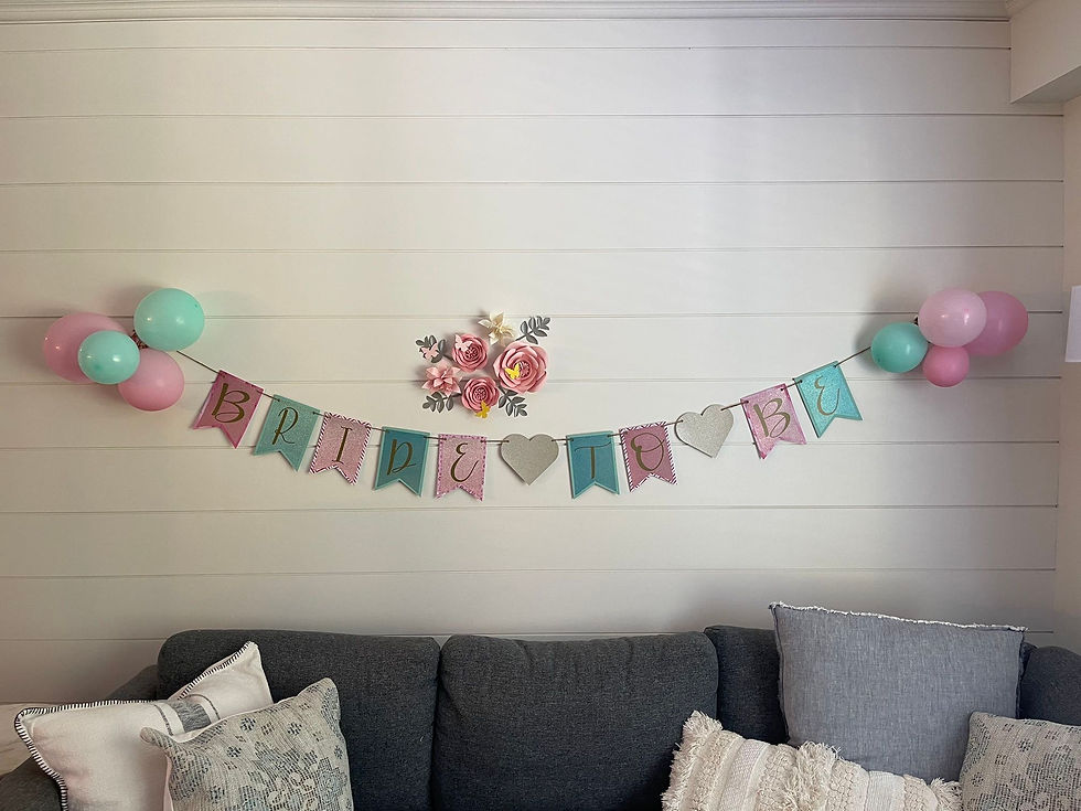 A shiplap wall over couch with decorative Bride to be Banner